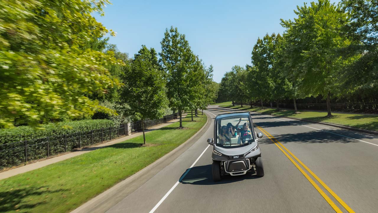 cru-neighborhood-electric-vehicle-driving-on-road-